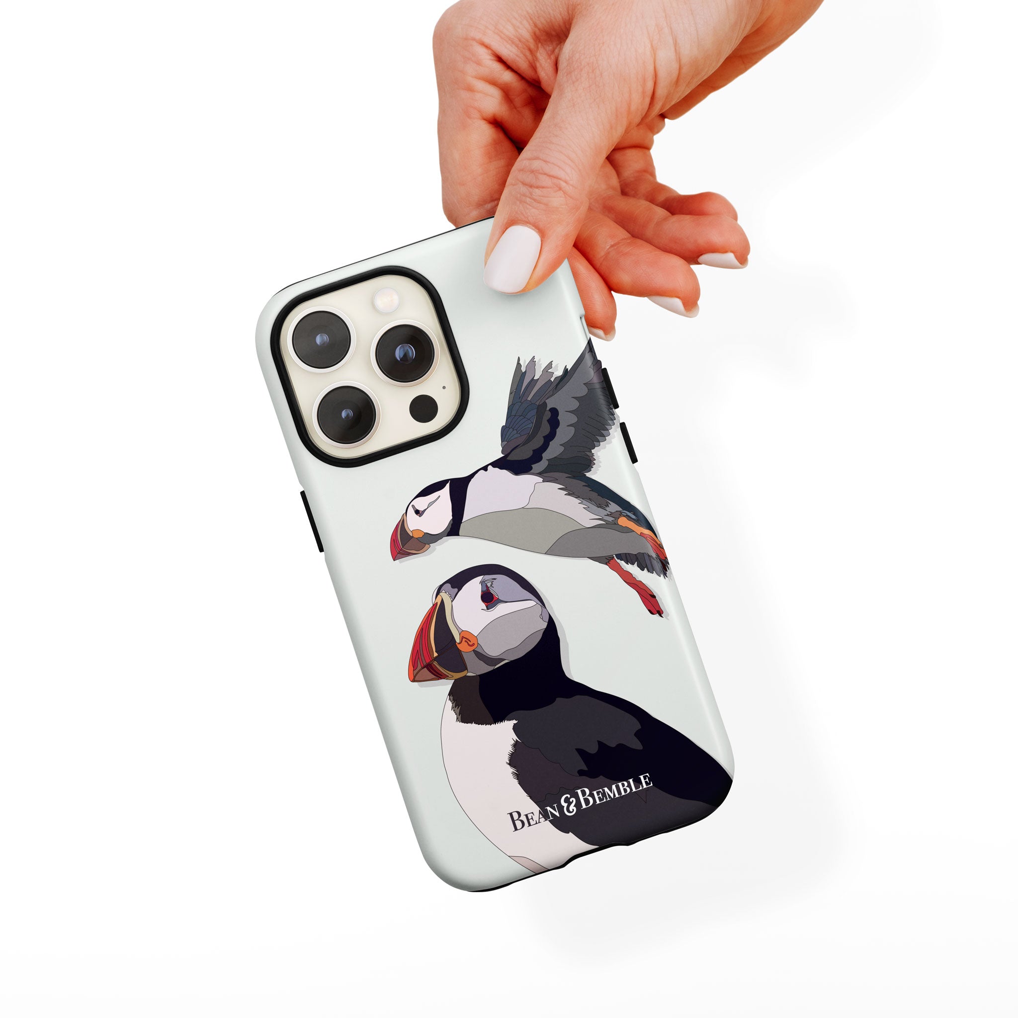 Hand holding a puffins phone case, showing its stylish bird illustration and protective design