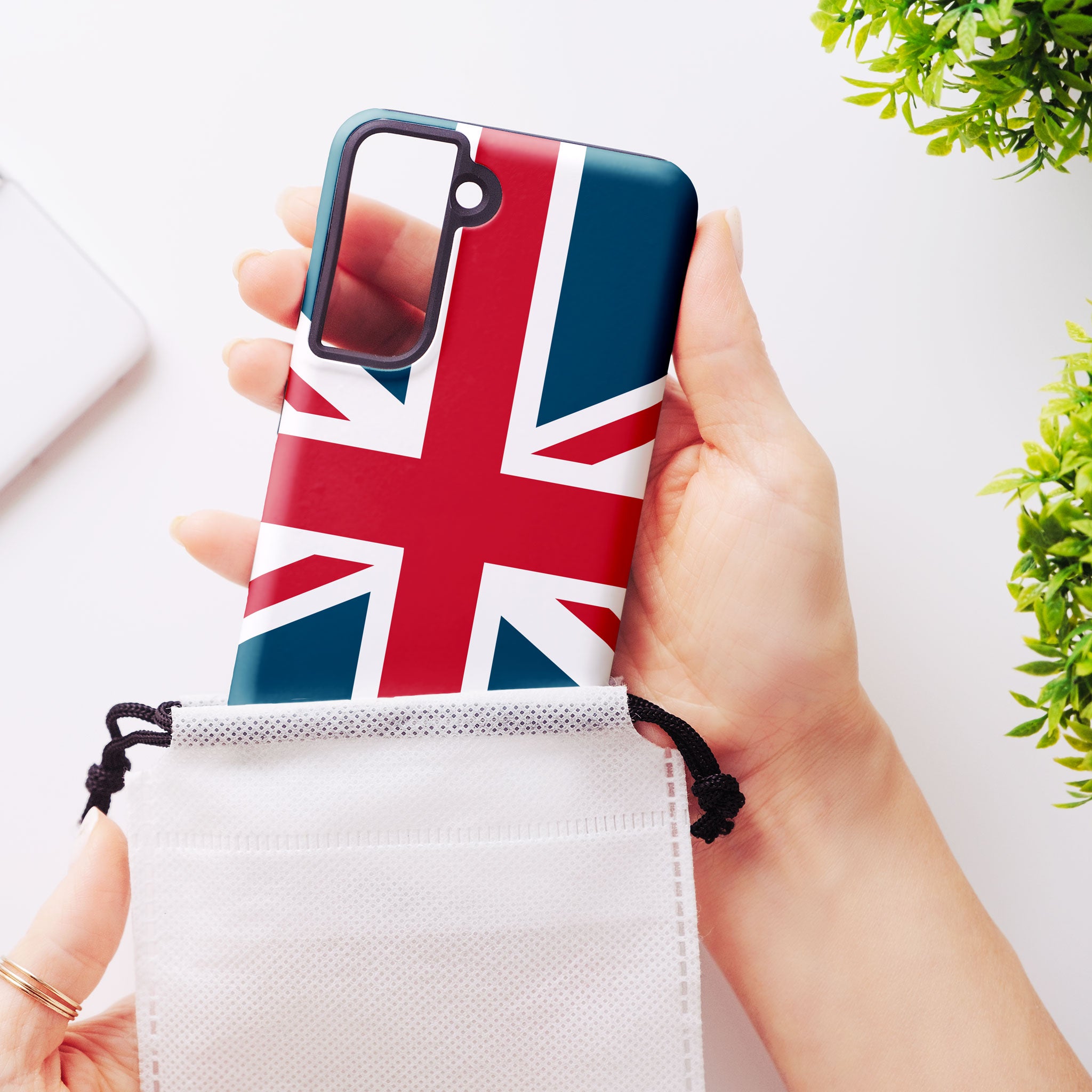 Union Jack phone case being removed from a protective pouch, designed for iPhone, Samsung Galaxy, Google Pixel, and LG models