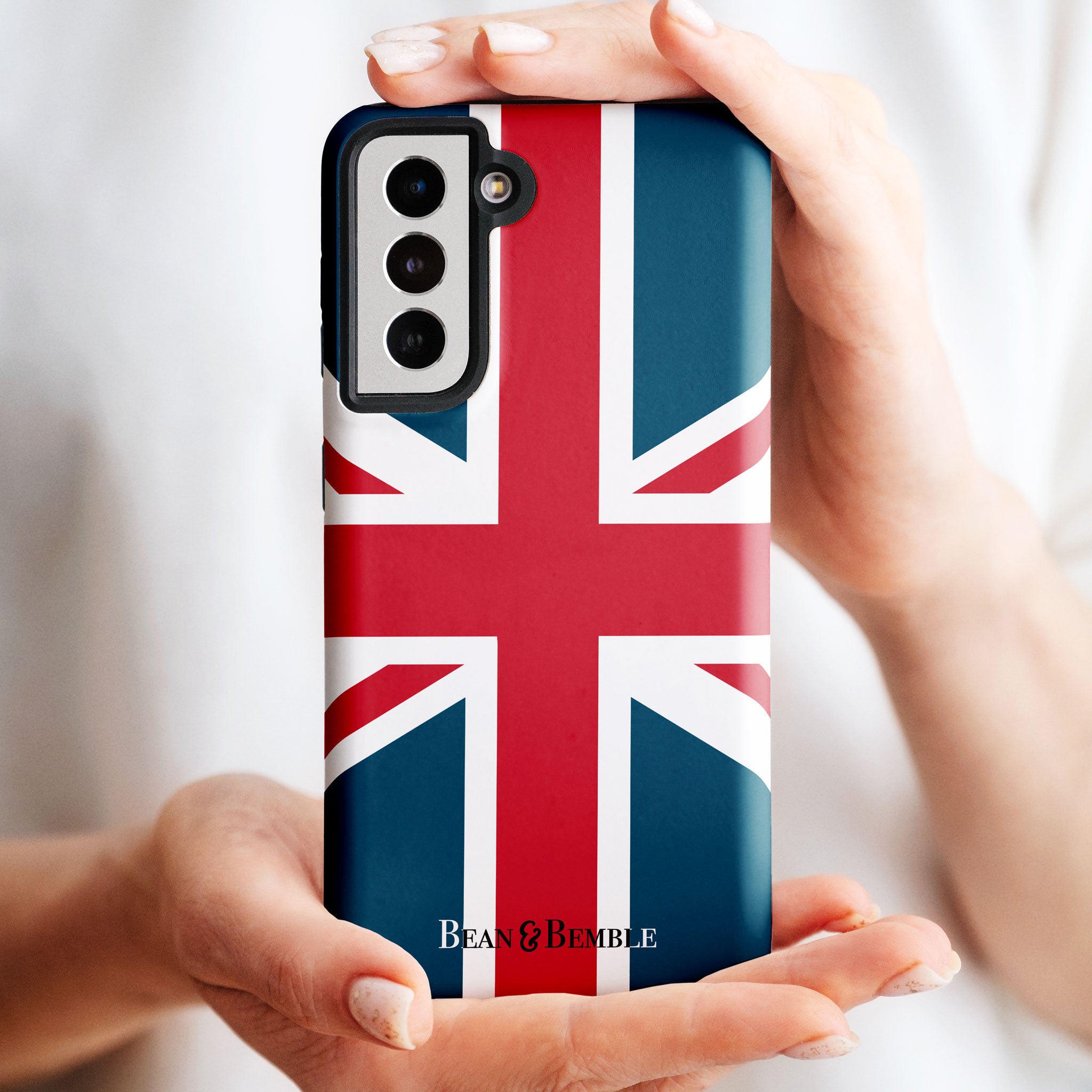 Close-up of a person holding a Union Jack phone case for iPhone, Samsung Galaxy, Google Pixel, and LG, showing precise camera cutouts